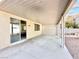 Covered patio with a sliding glass door that opens to a gravel-landscaped backyard at 1838 Fighting Falcon Ln, North Las Vegas, NV 89031