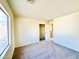 Bedroom features bright natural light, neutral walls, and carpet at 1838 Fighting Falcon Ln, North Las Vegas, NV 89031