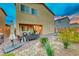 Landscaped backyard with patio furniture, grill, and a hammock at 200 Denette Ln, North Las Vegas, NV 89031