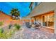 Landscaped backyard with patio furniture, grill, and a palm tree at 200 Denette Ln, North Las Vegas, NV 89031