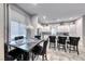 Kitchen dining area with dark wood table and six black velvet chairs at 200 Denette Ln, North Las Vegas, NV 89031