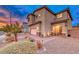 Two-story house with a landscaped front yard, driveway, and attached garage at 200 Denette Ln, North Las Vegas, NV 89031