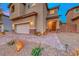 Two-story house with a landscaped front yard and attached garage, at dusk at 200 Denette Ln, North Las Vegas, NV 89031