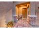 Inviting front porch with a stone patio and brown front door at 200 Denette Ln, North Las Vegas, NV 89031