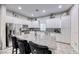 Granite kitchen island with seating, white cabinets, and stainless steel appliances at 200 Denette Ln, North Las Vegas, NV 89031