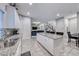 Open concept kitchen with large island, white cabinets and stainless steel appliances at 200 Denette Ln, North Las Vegas, NV 89031