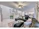 Open living room with sectional sofa and view into kitchen at 200 Denette Ln, North Las Vegas, NV 89031