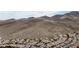 Aerial view of homes nestled in a scenic desert landscape with mountain backdrop at 2127 Sawtooth Mountain Dr, Henderson, NV 89044