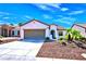 Single-story house with a two-car garage and desert landscaping at 2127 Sawtooth Mountain Dr, Henderson, NV 89044