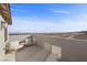 Balcony with comfortable seating and panoramic views of the distant desert landscape and horizon at 2384 Ridgeline Wash St, Las Vegas, NV 89138