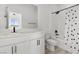 Modern bathroom featuring white cabinets, shower over tub and minimalist black faucet fixtures at 2384 Ridgeline Wash St, Las Vegas, NV 89138