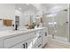 Bright bathroom featuring dual sinks, modern fixtures, and a glass-enclosed shower at 2384 Ridgeline Wash St, Las Vegas, NV 89138