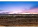 Distant city skyline view during sunset, showcasing vibrant colors and twinkling lights at 2384 Ridgeline Wash St, Las Vegas, NV 89138