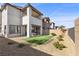 Two-story home showcasing the backyard with covered patio and low-maintenance landscaping at 2384 Ridgeline Wash St, Las Vegas, NV 89138