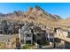 Community shot of new homes showcasing their varied architectural styles and beautiful mountain views at 2384 Ridgeline Wash St, Las Vegas, NV 89138