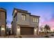 Modern two-story home with stone accents, a two-car garage, and desert landscaping at 2384 Ridgeline Wash St, Las Vegas, NV 89138