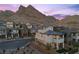 Beautiful shot of the home showcasing its neutral colors and desert landscape with a mountain backdrop at 2384 Ridgeline Wash St, Las Vegas, NV 89138