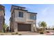 Exterior shot highlighting the home's two-car garage, neutral colors, and stone detailing at 2384 Ridgeline Wash St, Las Vegas, NV 89138