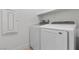 Well-equipped laundry room with modern, full-size, white washer and dryer at 2384 Ridgeline Wash St, Las Vegas, NV 89138