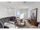 Bright upstairs living room showcasing a plush curved sectional and mountain views at 2384 Ridgeline Wash St, Las Vegas, NV 89138