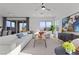 Bright living room featuring a sectional sofa, modern decor, and natural light at 2384 Ridgeline Wash St, Las Vegas, NV 89138