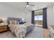 Comfortable main bedroom with ceiling fan, curtains and sliding glass door at 2384 Ridgeline Wash St, Las Vegas, NV 89138