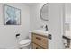 Modern powder room featuring a stylish vanity, round mirror, and abstract art at 2384 Ridgeline Wash St, Las Vegas, NV 89138