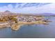 Beautiful view of a lake with waterfront homes, golf course and desert landscape at 24 Cerchio Alto, Henderson, NV 89011