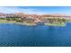 Aerial view of a beautiful lakefront property with views of the mountains and surrounding golf course at 24 Cerchio Alto, Henderson, NV 89011