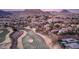 Aerial view of a beautiful desert community next to a golf course, set against a mountain backdrop at 24 Cerchio Alto, Henderson, NV 89011