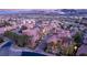 An elevated view of a red-roofed luxury development with a lush green golf course at 24 Cerchio Alto, Henderson, NV 89011