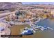 Panoramic aerial view of lakeside resort with buildings, boats, a dock, and mountain views with desert landscaping at 24 Cerchio Alto, Henderson, NV 89011