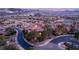 An aerial view of stunning multi-story residences, with golf course and mountain backdrop at 24 Cerchio Alto, Henderson, NV 89011