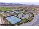 An aerial view showcasing the community's tennis courts, swimming pools, and surrounding landscape, highlighting its amenities at 24 Cerchio Alto, Henderson, NV 89011