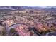 An aerial view of a sprawling residential area adjacent to a manicured golf course in a desert valley at 24 Cerchio Alto, Henderson, NV 89011