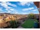 This cozy backyard features an easy to maintain synthetic lawn, privacy landscaping, and wrought iron fence at 24 Cerchio Alto, Henderson, NV 89011