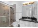 Bathroom featuring tiled walk-in shower, granite countertop vanity, toilet and updated lighting at 24 Cerchio Alto, Henderson, NV 89011