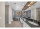 Well-lit bathroom with double sinks, granite counters, a soaking tub, and a glass-enclosed shower at 24 Cerchio Alto, Henderson, NV 89011