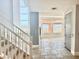 Grand entryway with tiled floor, staircase, and natural light from large windows overlooking mountain view at 24 Cerchio Alto, Henderson, NV 89011