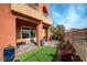 Exterior view showcasing a patio, artificial grass, plants, and a well-maintained garden area at 24 Cerchio Alto, Henderson, NV 89011