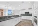 Modern kitchen featuring white cabinets, granite counters, and stainless steel appliances at 24 Cerchio Alto, Henderson, NV 89011