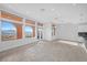 Bright living room with large windows, tiled floor, and access to the exterior balcony at 24 Cerchio Alto, Henderson, NV 89011