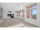 Bright living room with fireplace, tiled floor, and access to exterior balcony at 24 Cerchio Alto, Henderson, NV 89011