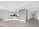 Open concept living room and kitchen area, with tile flooring and neutral color palette at 24 Cerchio Alto, Henderson, NV 89011