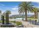 Gorgeous pool area featuring palm trees, lounge chairs, dining tables, and mountain views with a seating area at 24 Cerchio Alto, Henderson, NV 89011