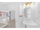 Modern powder room featuring pedestal sink, mirror, and sleek fixtures adjacent to the living room at 24 Cerchio Alto, Henderson, NV 89011