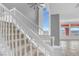 Carpeted staircase with white railing and a large window providing natural light and views at 24 Cerchio Alto, Henderson, NV 89011