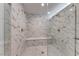 Large walk-in shower with marble tile and built-in seat at 247 Dougram Ave, Las Vegas, NV 89101