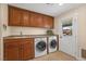 Laundry room with washer, dryer, cabinets, and exterior access at 250 Tonalea Ave, Henderson, NV 89015