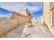 Backyard featuring a concrete patio, block walls, and stucco exterior of surrounding homes at 2727 Scotch Heather St, Las Vegas, NV 89142